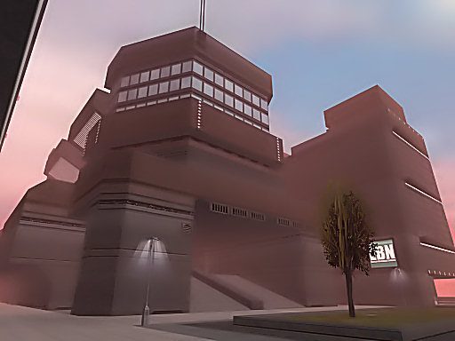 A futuristic building with multiple levels and a colorful sky in the background.