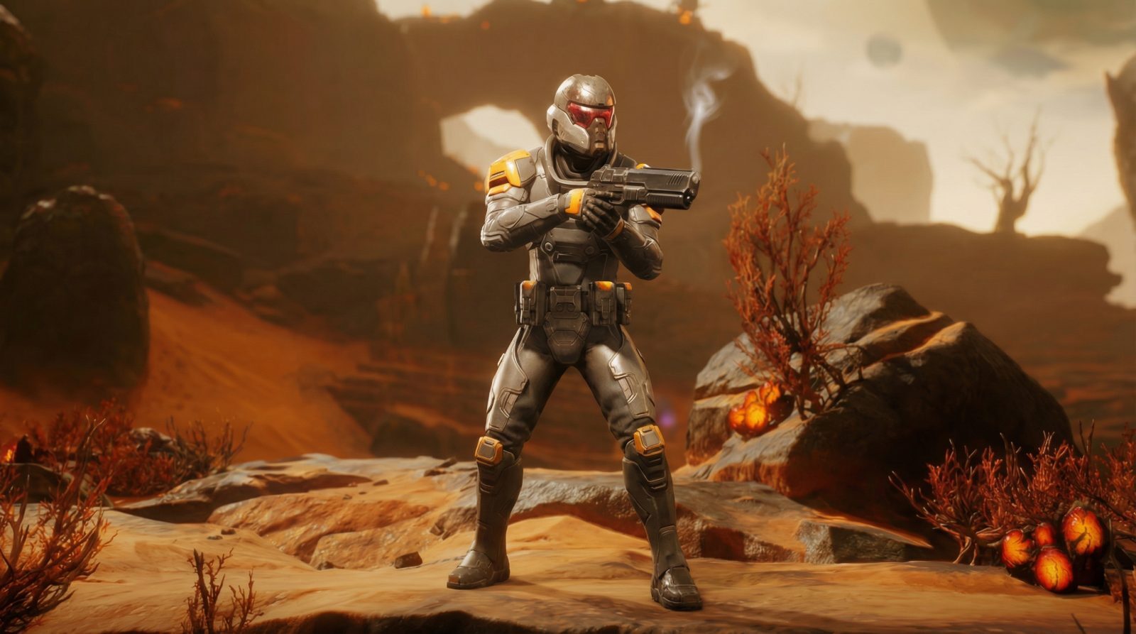 A soldier in armored gear stands in a desert landscape, holding a handgun with smoke rising from it. The background includes rocky formations and sparse vegetation, with a warm, hazy atmosphere.