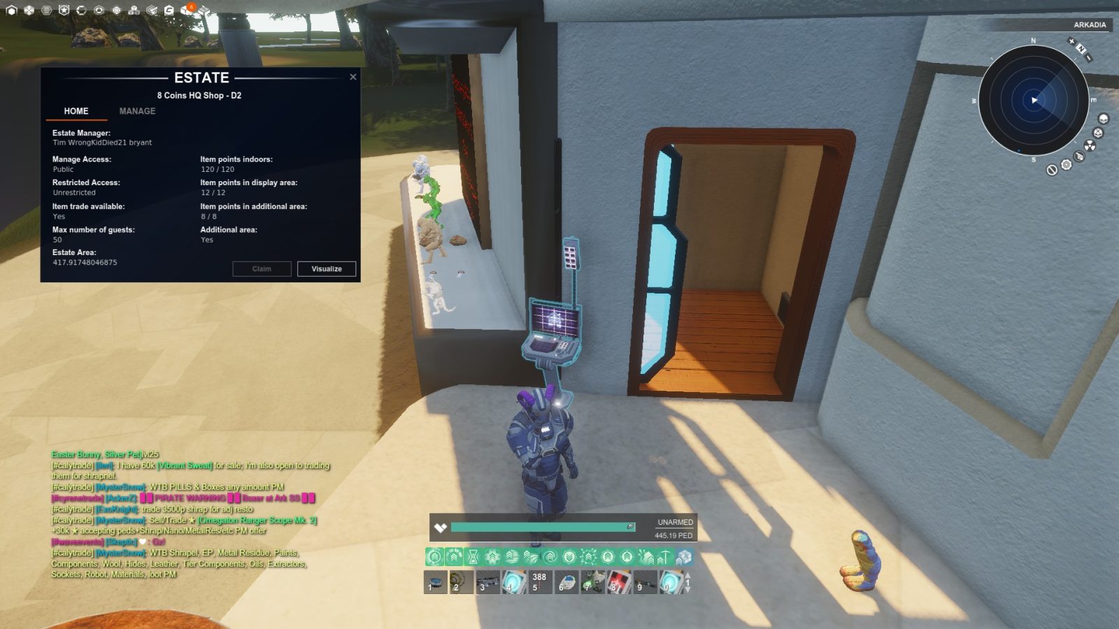 A player in a futuristic suit stands next to an estate management interface displaying estate details. Colorful decorative items are on a shelf beside them, and a small object is on the ground. The environment features sandy terrain and sunlight.