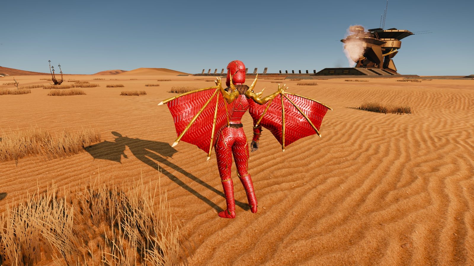 A red-winged figure stands in a sandy desert landscape with sparse grass and a futuristic building in the background.